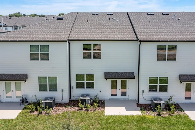 rear view of house featuring french doors and cooling unit