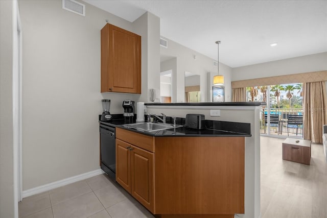 kitchen with pendant lighting, sink, light tile patterned floors, dishwasher, and kitchen peninsula