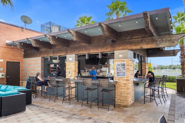 view of patio / terrace featuring fence and outdoor dry bar