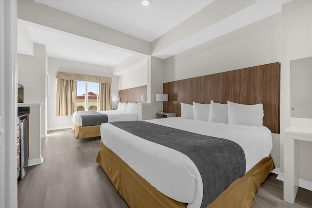 bedroom featuring baseboards and wood finished floors