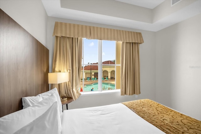 bedroom featuring visible vents and multiple windows
