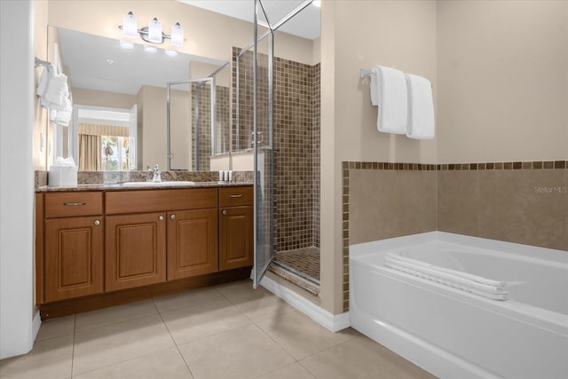 full bathroom with vanity, tile patterned flooring, a bath, and a shower stall