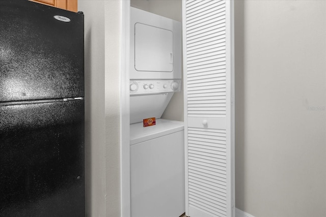 clothes washing area with laundry area and stacked washer / dryer