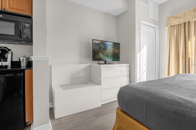 bedroom with visible vents and wood finished floors