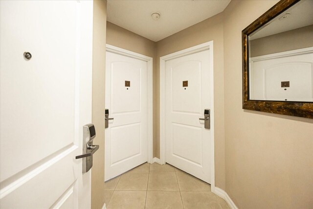 7383 Universal Blvd Unit 207, Orlando, FL 32819 - entryway with light tile patterned floors and baseboards