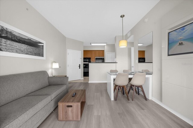 7383 Universal Blvd Unit 207, Orlando, FL 32819 - living room featuring light wood-style floors