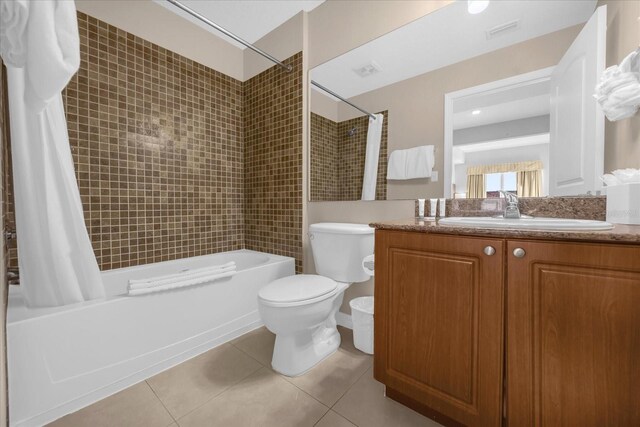 7383 Universal Blvd Unit 207, Orlando, FL 32819 - bathroom featuring shower / bathtub combination with curtain, vanity, tile patterned floors, and toilet