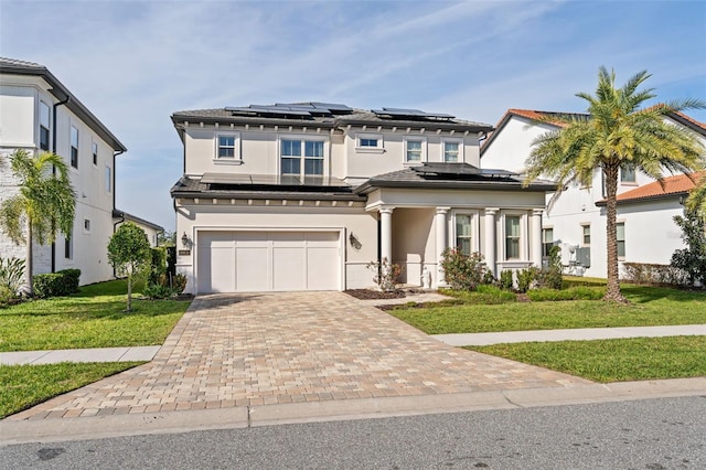 view of front of home with a garage and a front lawn