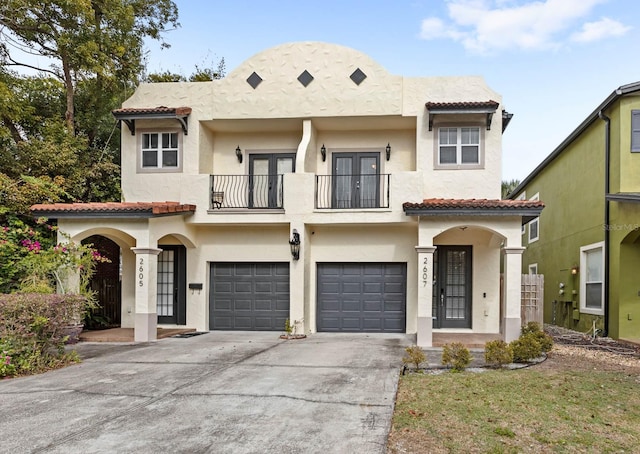 view of front facade with french doors, a balcony, and a garage