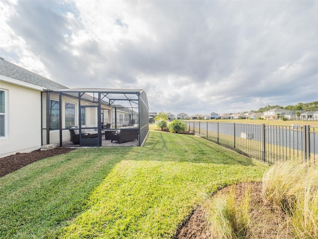 view of yard with glass enclosure