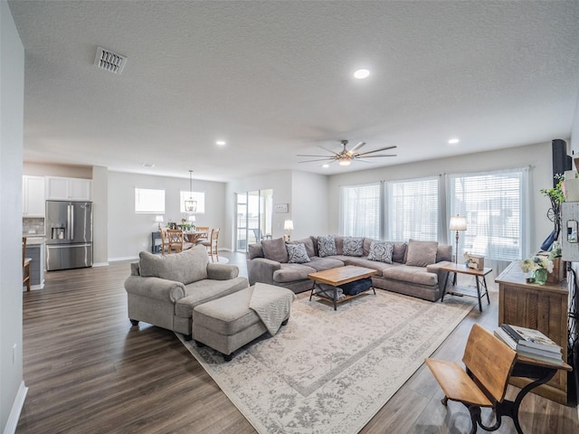 living room with plenty of natural light and dark hardwood / wood-style flooring