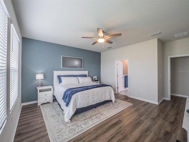 bedroom featuring ensuite bathroom, dark wood-type flooring, and ceiling fan