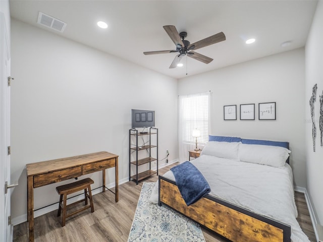 bedroom with light hardwood / wood-style floors and ceiling fan