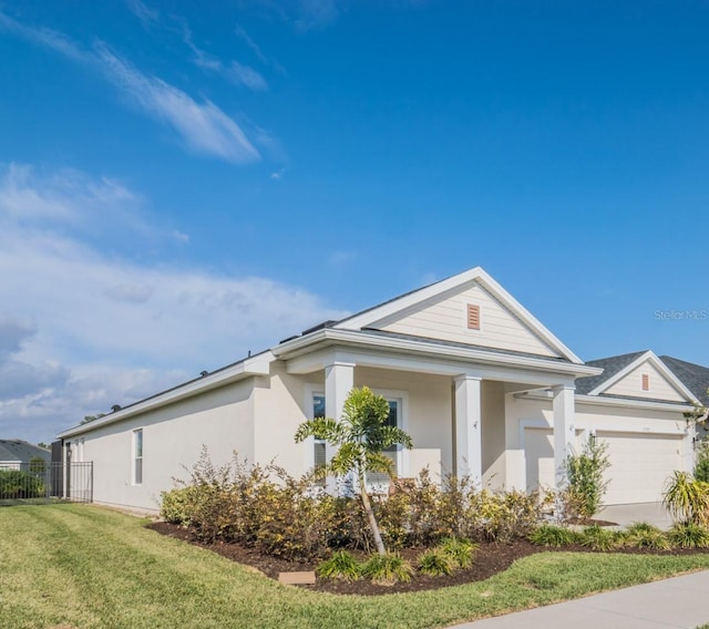 view of front facade with a garage and a front lawn