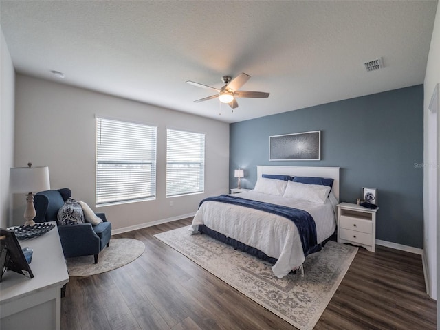 bedroom with dark wood-type flooring and ceiling fan