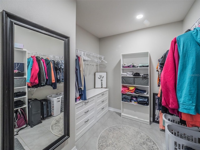 walk in closet with light tile patterned floors