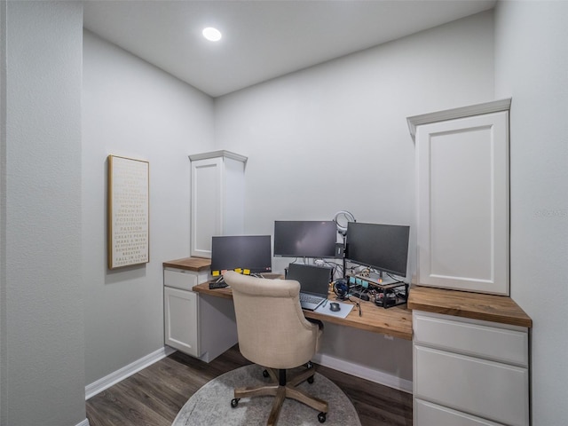 home office with dark hardwood / wood-style flooring