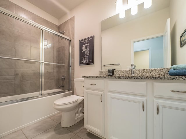 full bathroom featuring toilet, vanity, shower / bath combination with glass door, and tile patterned flooring