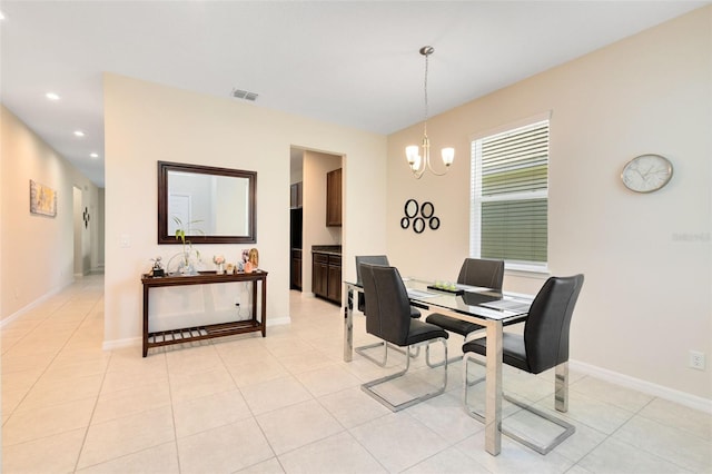 dining room featuring light tile patterned floors and a chandelier