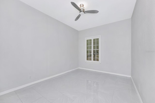 empty room featuring light tile patterned flooring and ceiling fan