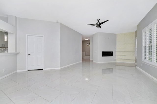 unfurnished living room featuring ceiling fan