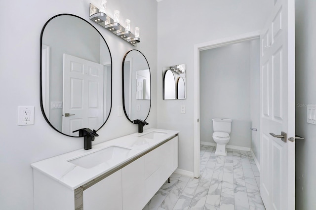 bathroom featuring vanity and toilet