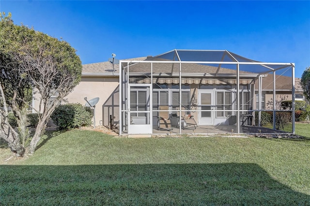 back of property featuring a lanai, a patio area, and a lawn