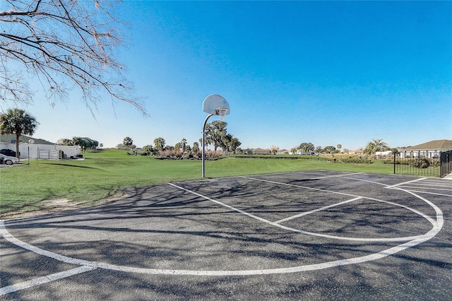 view of basketball court with a lawn