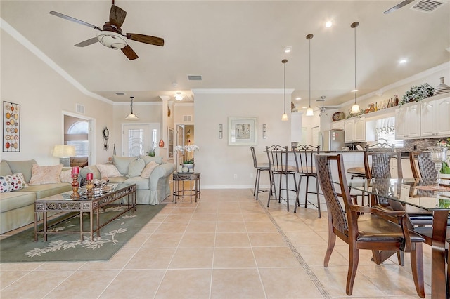 tiled living room with ceiling fan and crown molding