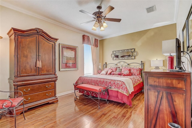 bedroom featuring ceiling fan, light wood-type flooring, and ornamental molding