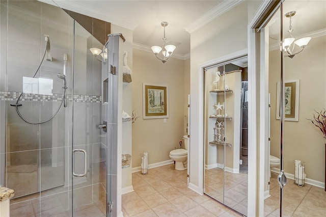 bathroom with tile patterned floors, an inviting chandelier, toilet, and walk in shower