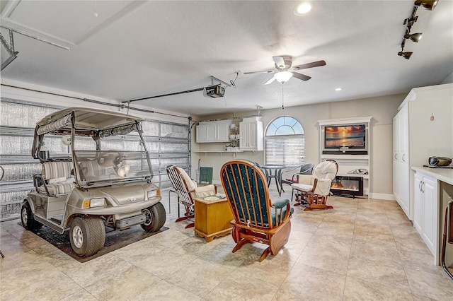 garage featuring ceiling fan and a garage door opener