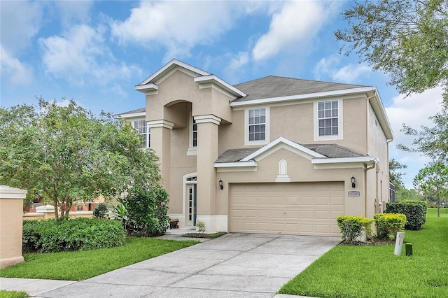 view of front property featuring a front lawn and a garage