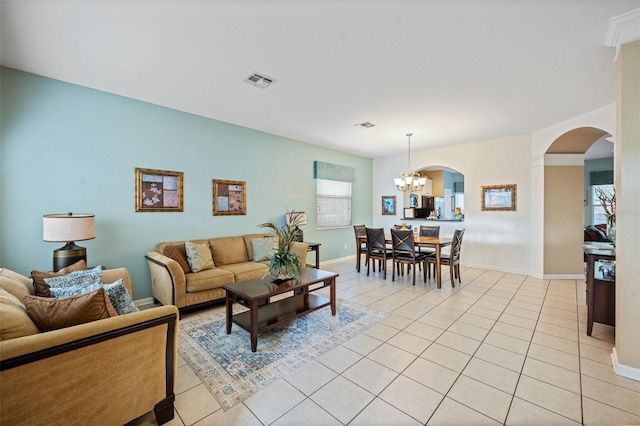 living room featuring a chandelier and light tile patterned floors