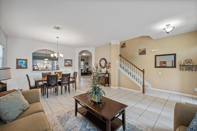 living room with light tile patterned floors and a chandelier