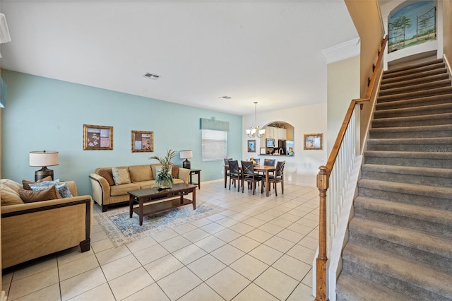 living room featuring light tile patterned flooring and an inviting chandelier