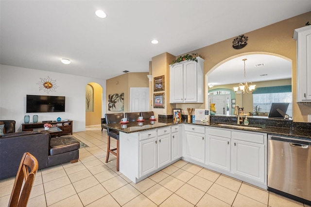 kitchen with dishwasher, white cabinets, sink, hanging light fixtures, and kitchen peninsula