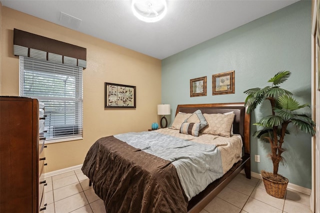 bedroom with light tile patterned floors