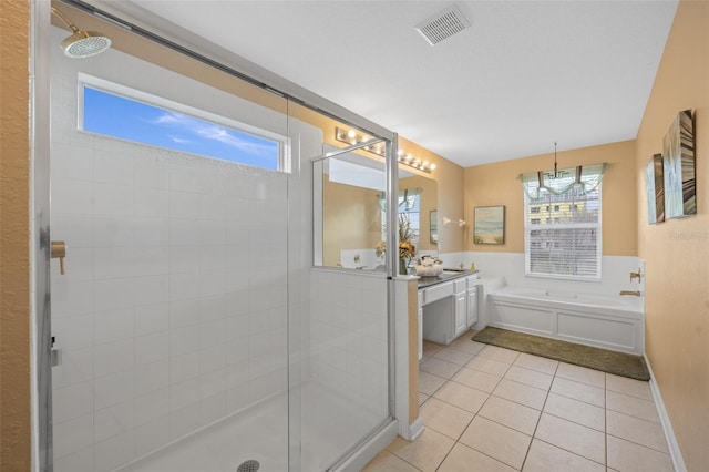 bathroom featuring tile patterned floors, vanity, and shower with separate bathtub