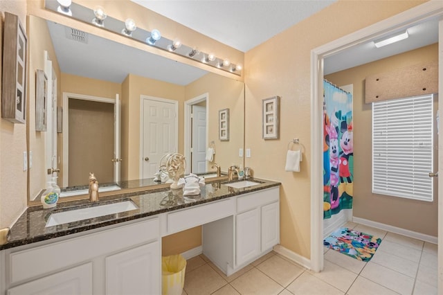 bathroom with tile patterned floors, curtained shower, and vanity