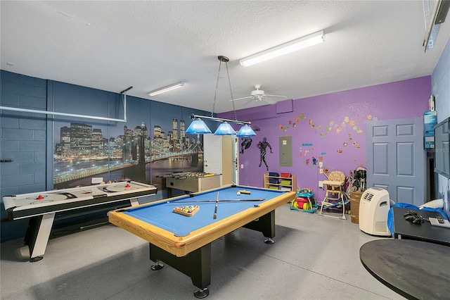 rec room with ceiling fan, electric panel, a textured ceiling, and pool table