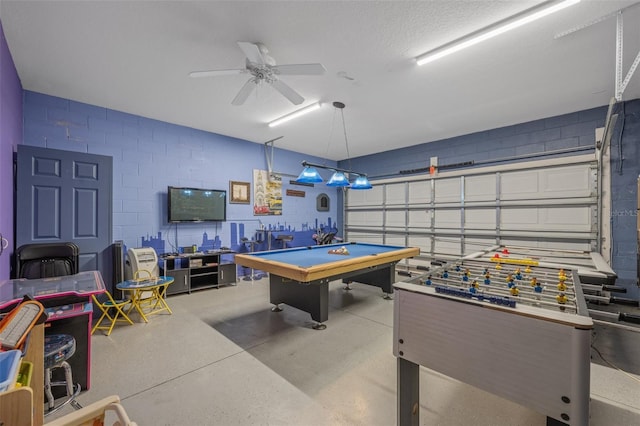 playroom with a textured ceiling, ceiling fan, and pool table