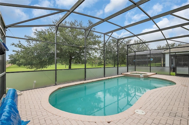 view of pool featuring glass enclosure, a patio area, and an in ground hot tub