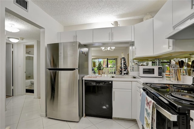 kitchen with exhaust hood, light tile patterned floors, white cabinetry, stainless steel appliances, and a chandelier