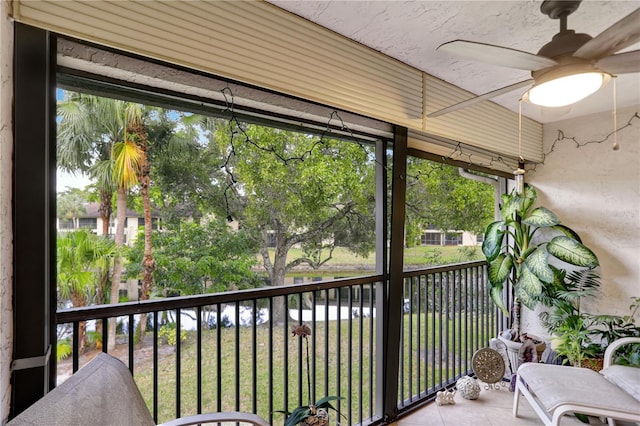 unfurnished sunroom featuring ceiling fan