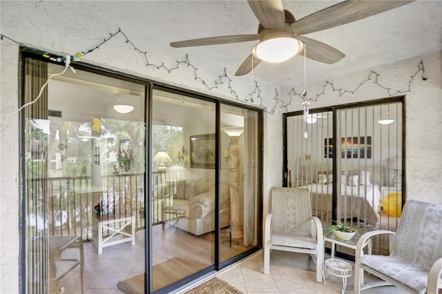 interior space with ceiling fan and tile patterned flooring