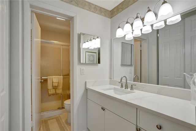 bathroom featuring vanity, toilet, and an enclosed shower