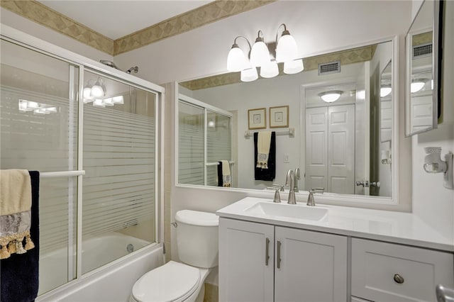 full bathroom with vanity, toilet, and bath / shower combo with glass door