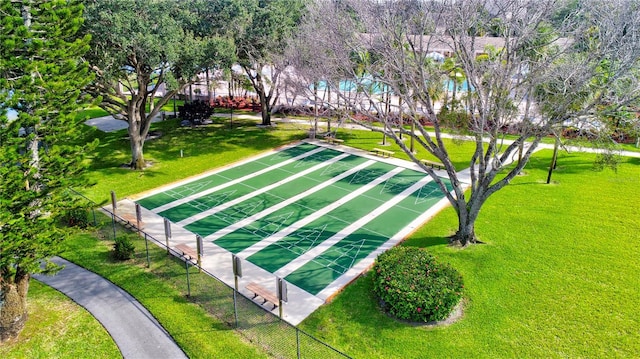 view of property's community featuring a yard