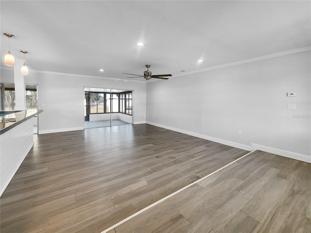 unfurnished living room featuring ceiling fan, dark hardwood / wood-style flooring, and crown molding